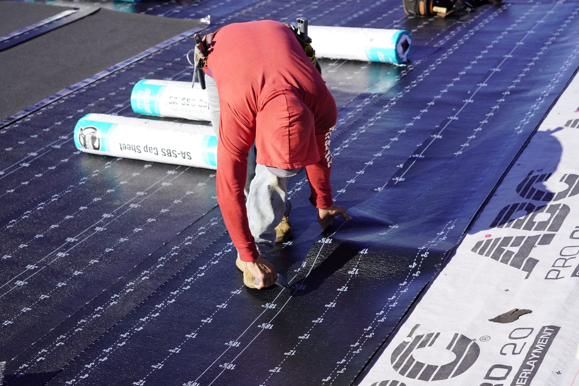 Roofer hand-installing shingles