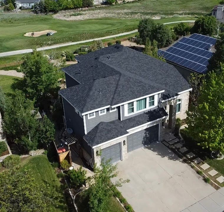 Completed roof on a home beside a golf course in Elizabeth, Colorado, aerial view