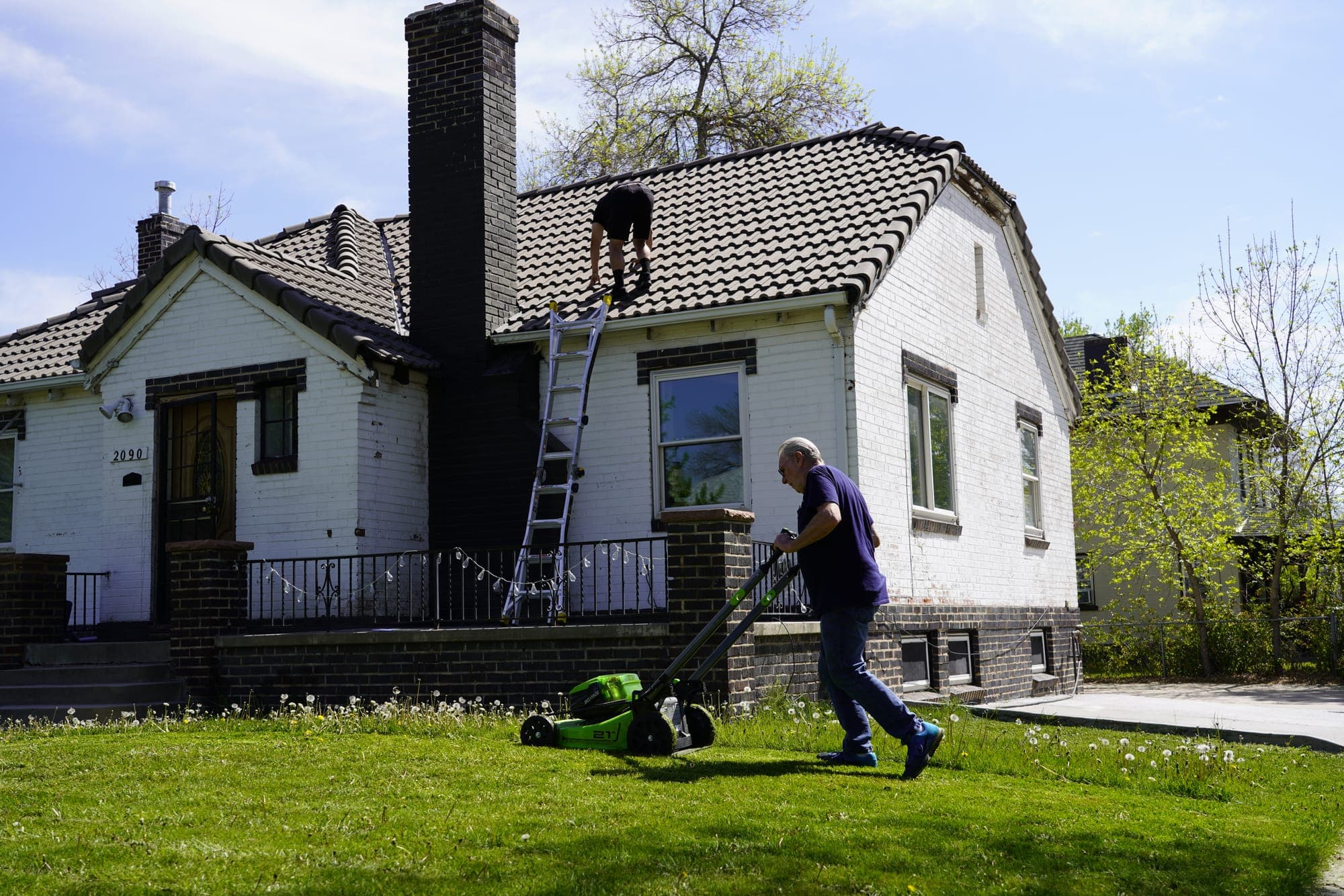 Upstream Roofers inspecting a roof for storm damage