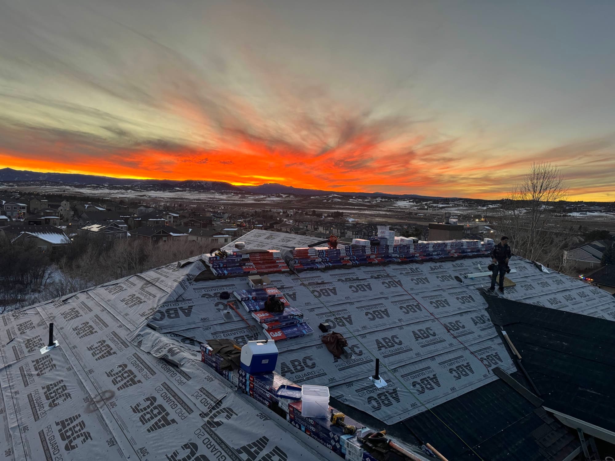 Sunrise over a Front Range roof during a re-roof