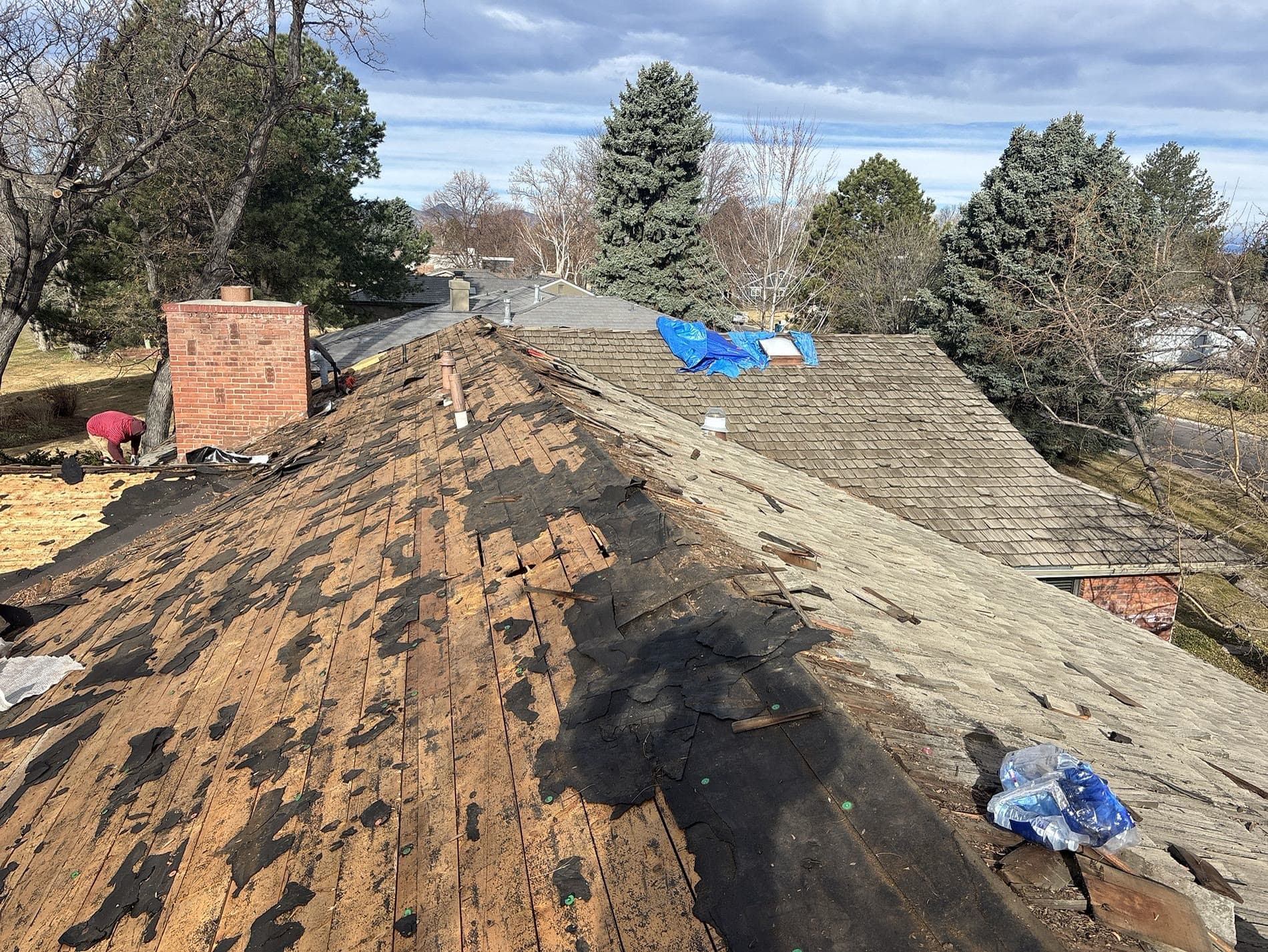 Roof torn off down to the decking before a re-roof, aerial view